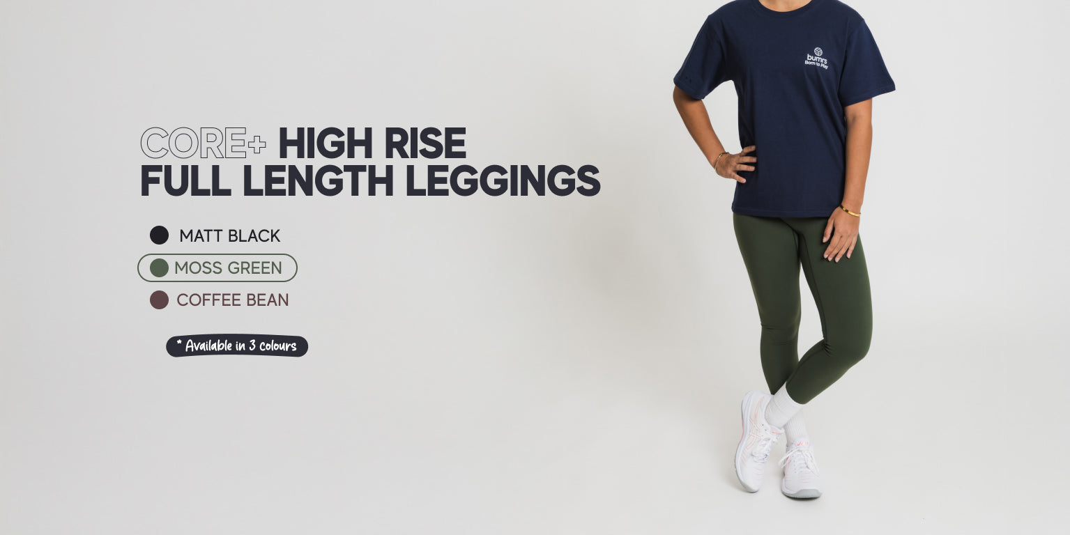 Person wearing a navy t-shirt and green high rise full length leggings on a white background with text about leggings.